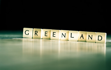 Greenland word made of tiles on dark wooden background