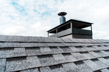 Selective Focus Of Modern Chimney On Rooftop Of House