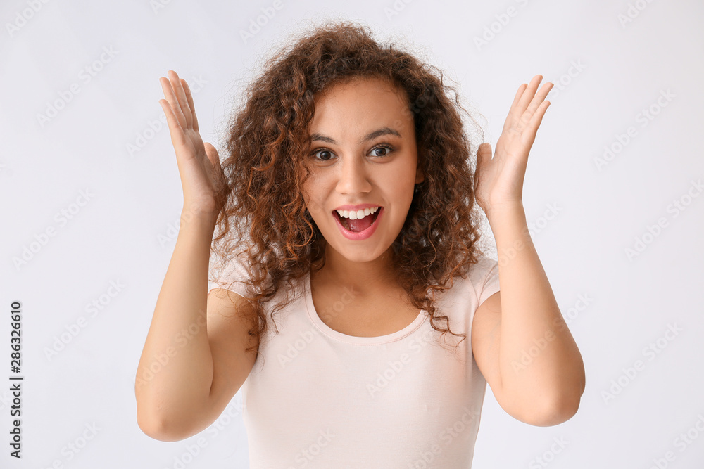Happy African-American woman on white background