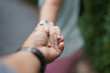 selective focus on hands of couple.Walking hand of traveler travel nature Forests.Woman holding boyfriend's hand traveling in garden park .