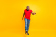 © deagreez - Full length body size photo of angry furious yelling commanding black man wearing jeans denim screaming into camera while isolated with yellow vivid background