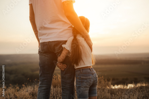 Cuadros en Lienzo Happy father and daughter hugging while standing at countryside