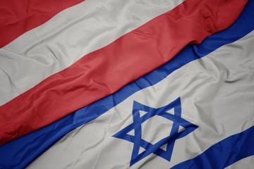 waving colorful flag of israel and national flag of austria.