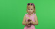 © Andrii Iemelianenko - Child in pink swimsuit drinks juice cocktail with drinking straw. Chroma Key