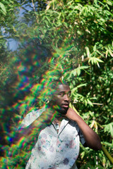 model fixing collar on a natural green background and rainbow reflection