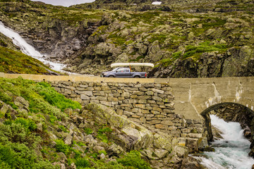 Wall Mural - Car with canoe on top in mountains