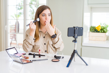 Sticker - Beautiful young influencer woman recording make up video tutorial cover mouth with hand shocked with shame for mistake, expression of fear, scared in silence, secret concept