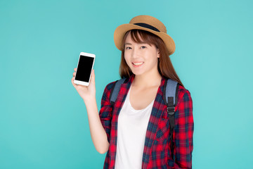 Beautiful young asian woman showing smart mobile phone for presenting something in travel summer trip in vacation isolated on blue background, asia girl holding smartphone, holiday concept.