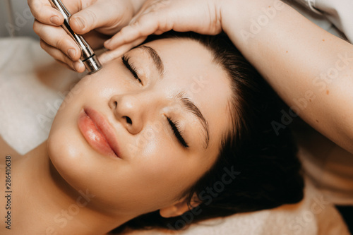 close-up-of-a-lovely-caucasian-woman-having-microdermabrasion-non-invasive-therapy-with-derma-pen-in-a-wellness-center