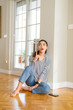 © Krakenimages.com - Beautiful young woman smiling cheerful pointing to the side with fingers sitting on the floor