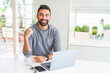 © Krakenimages.com - Handsome hispanic man working using computer laptop with surprise face pointing finger to himself