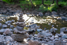 Zen Stone Cairn Along Forest Stream