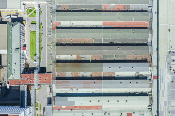 Wall Mural - roof of large warehouse at city industrial area, aerial top view