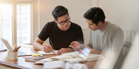 Wall Mural - Two college men discussing the group projects together