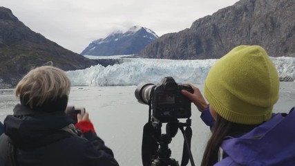 Wall Mural - Alaska Glacier Bay Tourists looking at Margerie Glacier taking pictures on cruise ship using SLR camera and phone. People on vacation travel cruising famous destination.