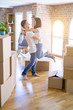 © Krakenimages.com - Young beautiful couple hugging at new home around cardboard boxes