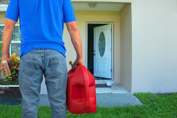 arsonist man with red plastic gasoline can container and box of striking matches preparing to commit