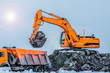 © Алексей Закиров - Excavators and heavy machinery in the works of stone movement in a quarry stone extraction for its transformation into gravel. Close-up of a construction site excavator.