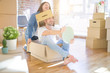 © Krakenimages.com - Funny and crazy couple having fun riding a cardboad box as a car, smiling happy and laughing at new home