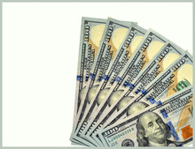 Seven One Hundred Dollar Bills Fanned Out On An Off White Background, United States Currency, Isolated