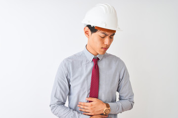 Sticker - Chinese architect man wearing tie and helmet standing over isolated white background with hand on stomach because indigestion, painful illness feeling unwell. Ache concept.