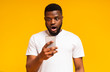 © Prostock-studio - Shocked african man looking at smartphone screen in amazement
