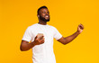 © Prostock-studio - Handsome african man enjoying listening favorite music on smartphone