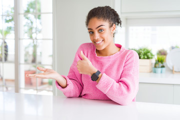 Sticker - Beautiful african american woman with afro hair wearing casual pink sweater Showing palm hand and doing ok gesture with thumbs up, smiling happy and cheerful