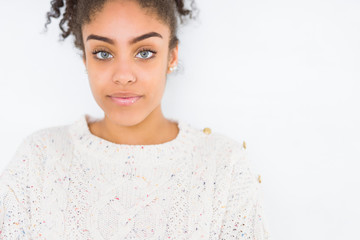 Canvas Print - Beautiful young african american woman with afro hair wearing casual sweater Relaxed with serious expression on face. Simple and natural with crossed arms