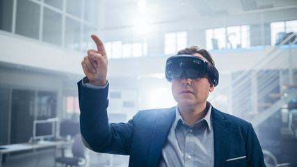 Poster - Automotive Engineer Using Augmented Reality Headset Making Touching Gestures. In Innovation Laboratory Facility Concept Vehicle Frame Includes Wheels, Suspension, Engine and Battery.