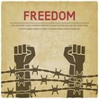 © natbasil - Fighting for freedom concept. Hands clenched into fist behind barbed wire vintage background