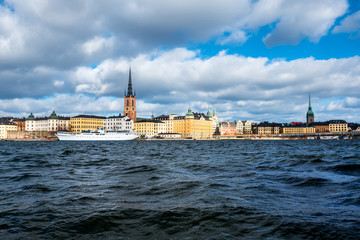 Wall Mural - View of Gamla Stan in Stockholm, Sweden with landmarks like Riddarholm Church during the cloudy and sunny day