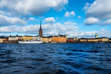Wall Mural - View of Gamla Stan in Stockholm, Sweden with landmarks like Riddarholm Church during the cloudy and sunny day