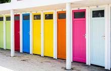 Row Of Public Changing Cubicles With Colorful Doors On The Beach Of Trestraou In Perros-Guirec, Brittany, France.