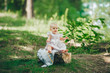 © Irina84 - Toddler little girl sits on a stump in summer forest.