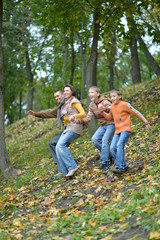 Wall Mural - Family of four having fun in autumn