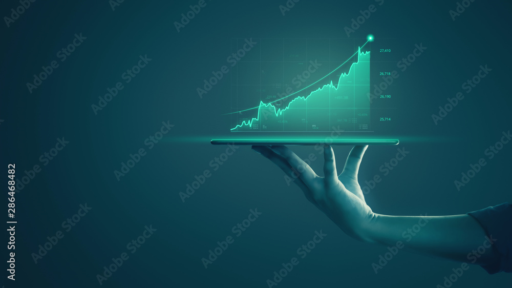 Businessman holding tablet and showing holographic graphs and stock market statistics gain profits. Concept of growth planning and business strategy. Display of good economy form digital screen. - obrazy, fototapety, plakaty 