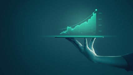 Wall Mural - Businessman holding tablet and showing holographic graphs and stock market statistics gain profits. Concept of growth planning and business strategy. Display of good economy form digital screen.