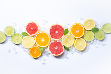 Colorful Fruits Backround. .citrus Slices,orange, Lemon, Lime, And Grapefruit With Ice And Mint. White Background. Top View