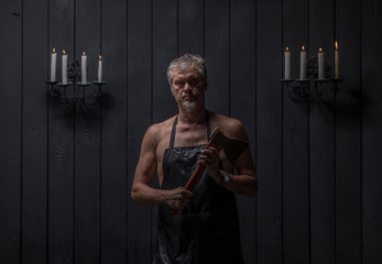 Wall Mural - portrait of a ripper butcher on a black background