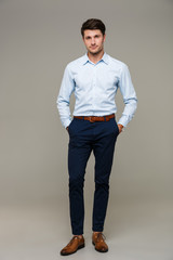 Sticker - Image of confident young man wearing shirt standing with hands in pockets