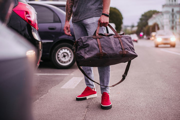 Young man with fashion bag on vacation