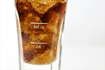 cola with ice in a glass isolated on white