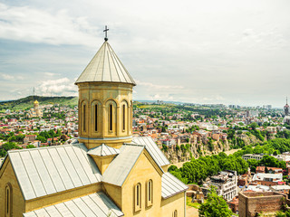 St. Nicholas church located inside famous Narikala fortress, Tbilisi, Georgia, with Holy Trinity Cathedral and houses of the Old Town seen in the background