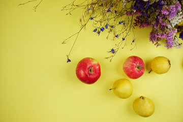 Canvas Print - Apples and pears on a yellow background. View from above