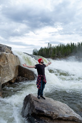 Fototapete - Young Man hiking outdoor Lifestyle Travel survival concept river and rocky mountains on background