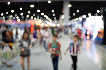 Wall Mural - Blurred images of trade fairs in the big hall. image of people walking on a trade fair exhibition or expo where business people show innovation activity and present product in a big hall.