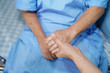 © amazing studio - Holding Touching hands Asian senior or elderly old lady woman patient with love, care, helping, encourage and empathy at nursing hospital ward : healthy strong medical concept