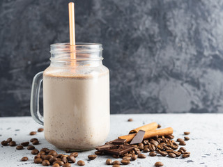 Wall Mural - Glass jar of chocolate coffee milk smoothie cocktail on grey table with copyspace