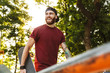 © Drobot Dean - Happy cheerful young man walking at the skate park ramp